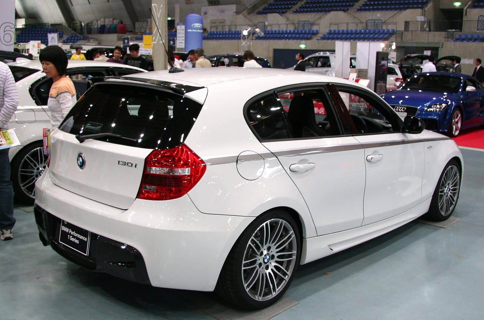 White BMW 130i at a motor show, rear three-quarter view