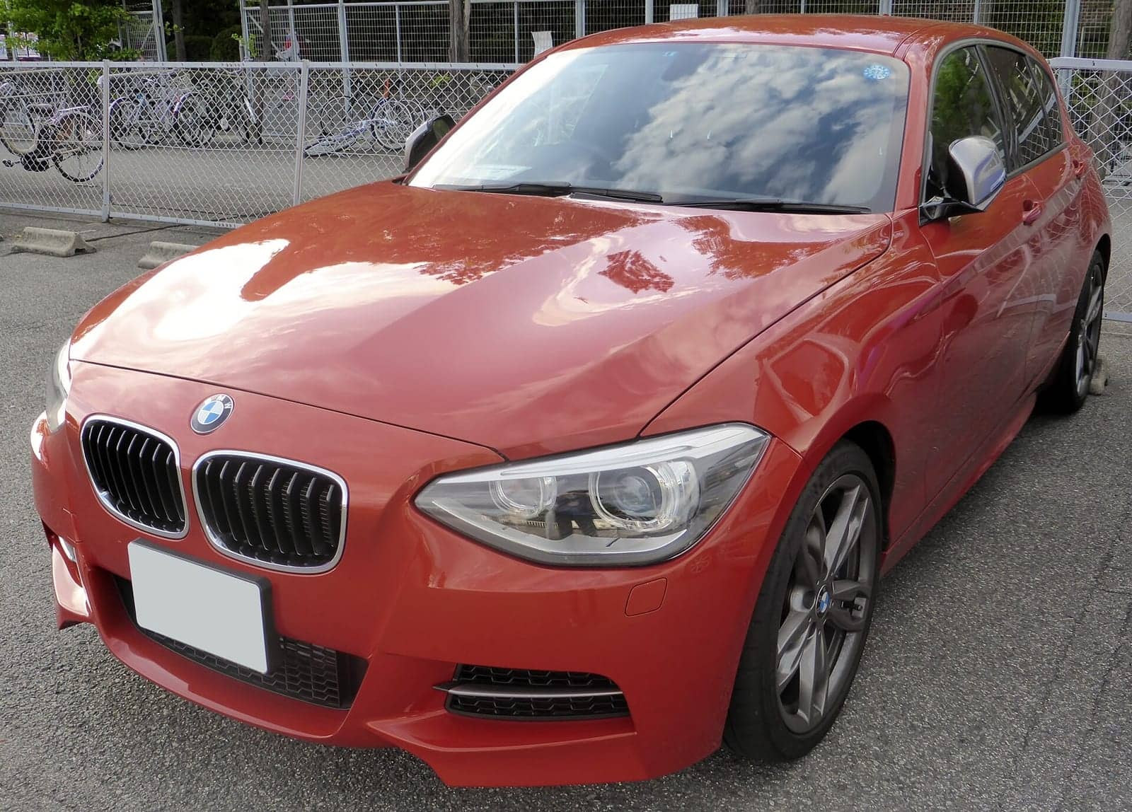 Orange BMW M135i five-door, front three-quarter view