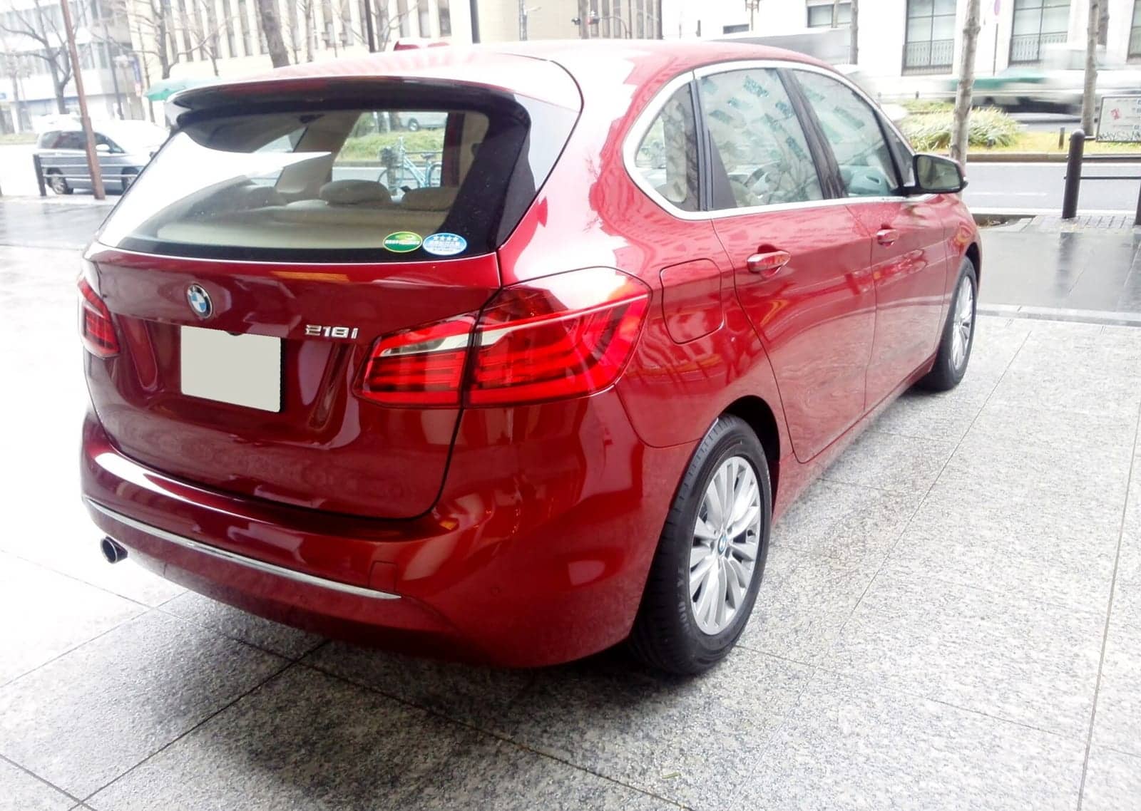 Red BMW 218i Active Tourer, rear three-quarter view