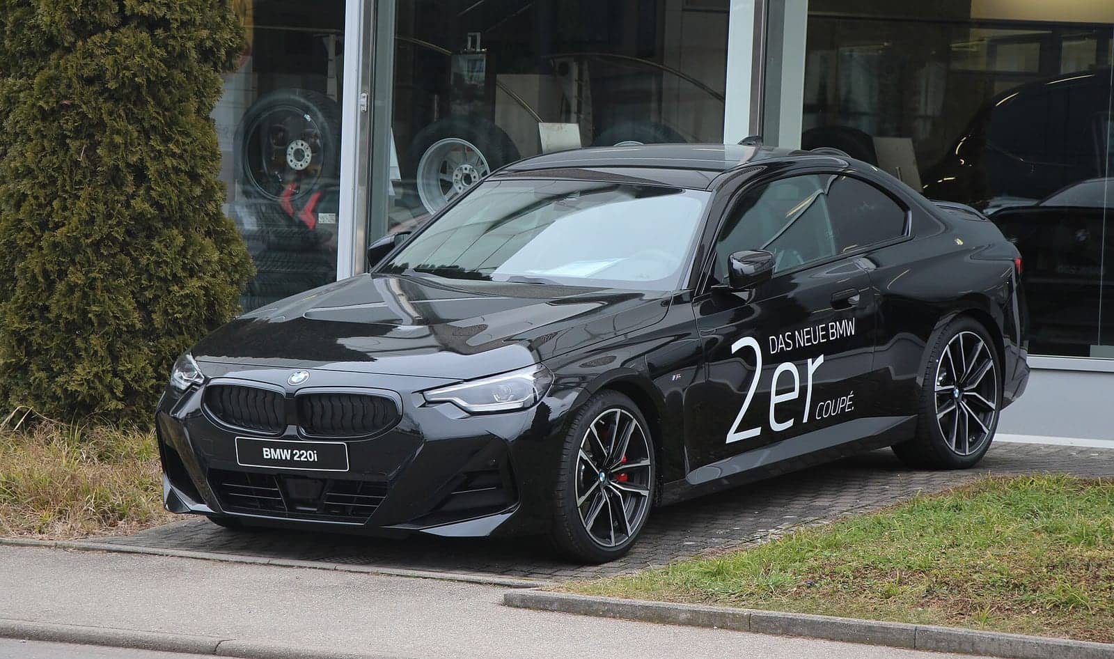 Black BMW 220i coupé, front three-quarter view