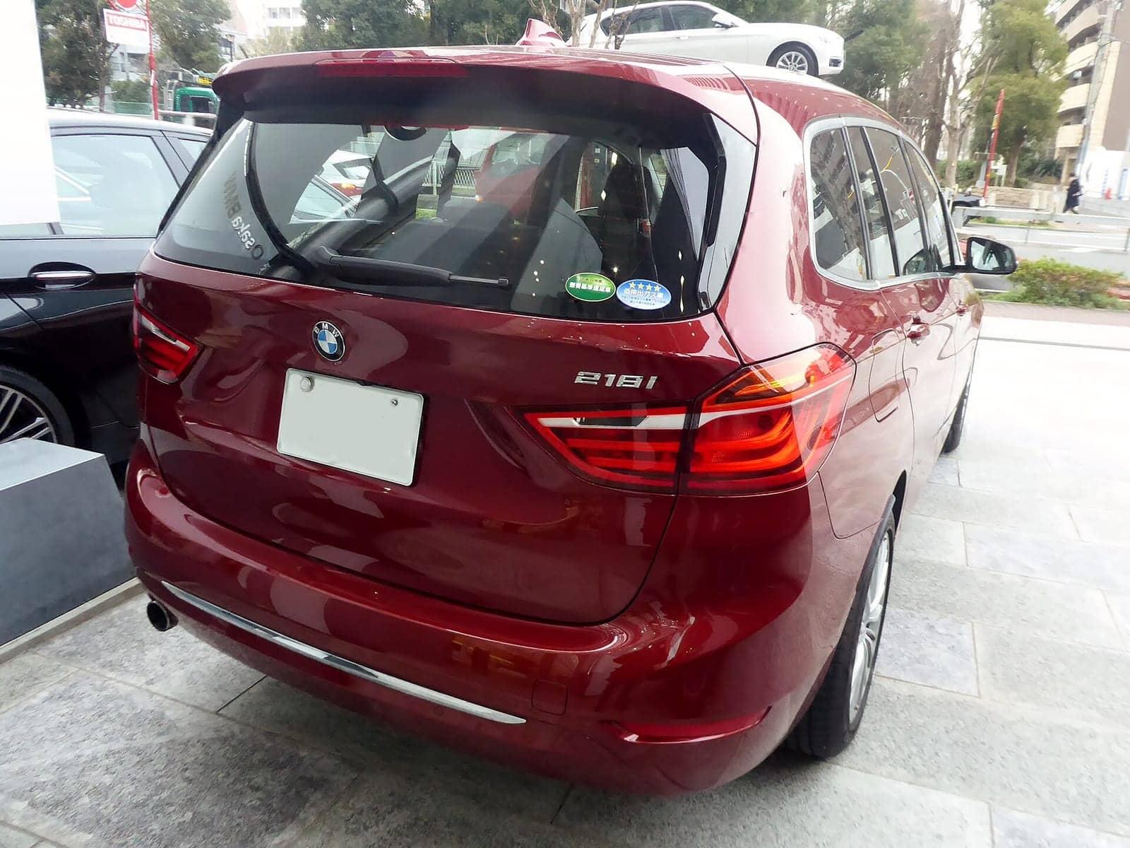 Red BMW 218i Gran Tourer Luxury, rear three-quarter view