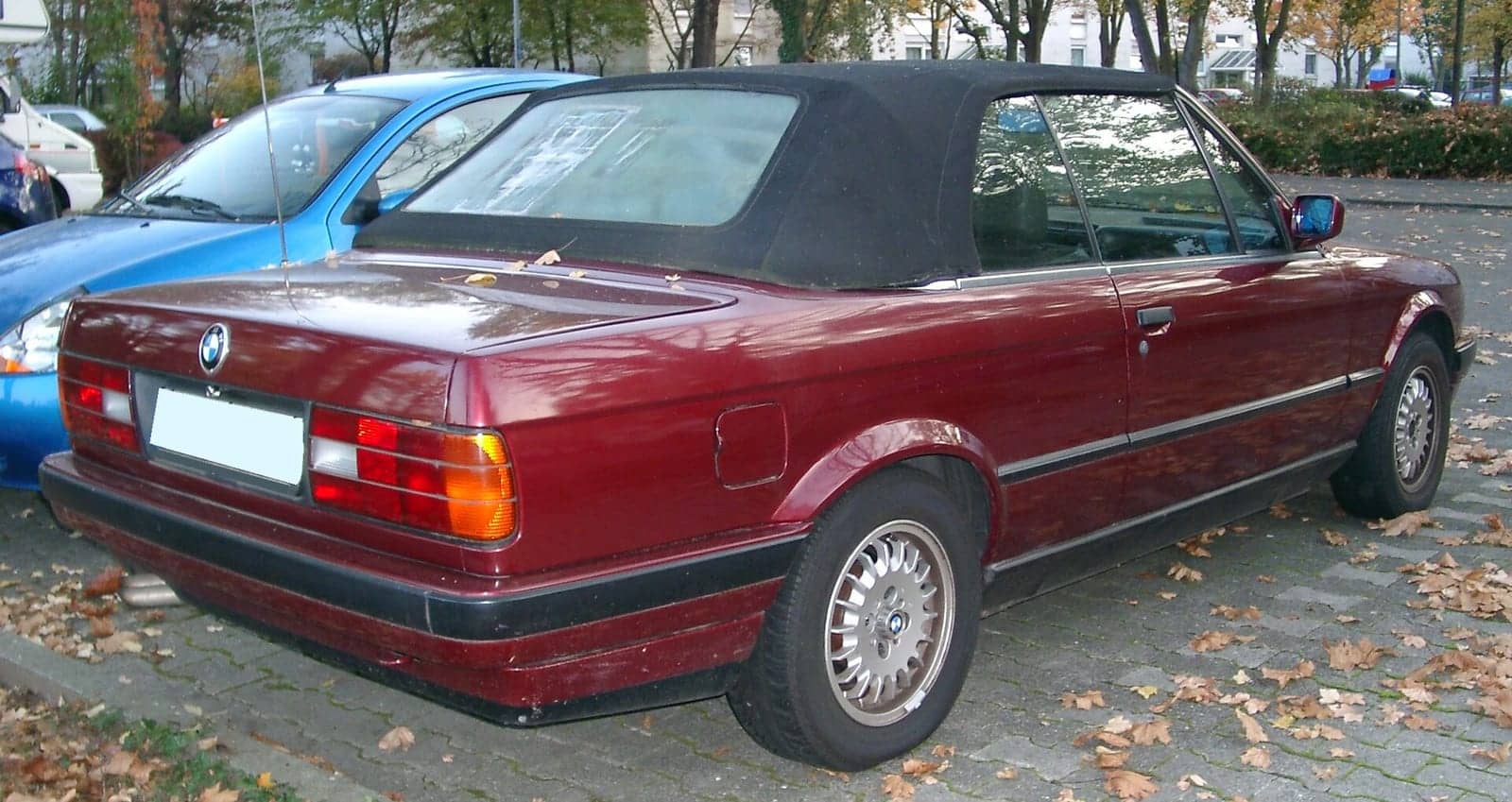 Maroon BMW 3 Series convertible, rear three-quarter view