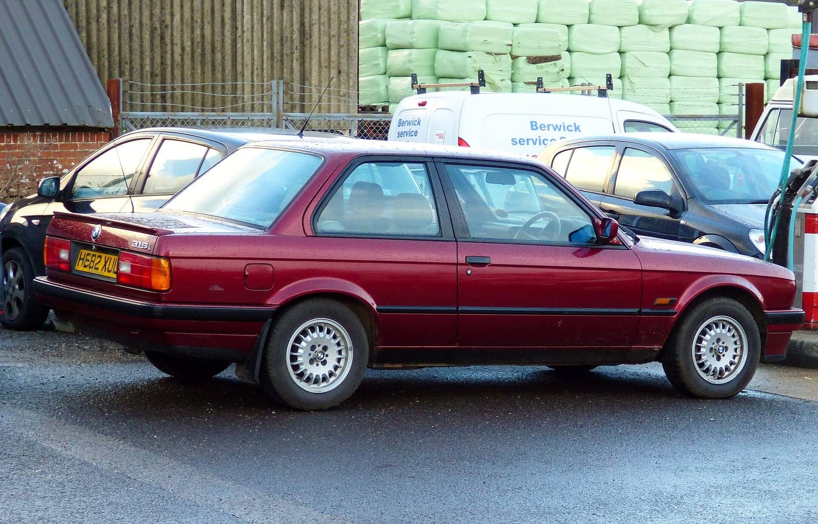 Dark red BMW 316i two-door, rear three-quarter view