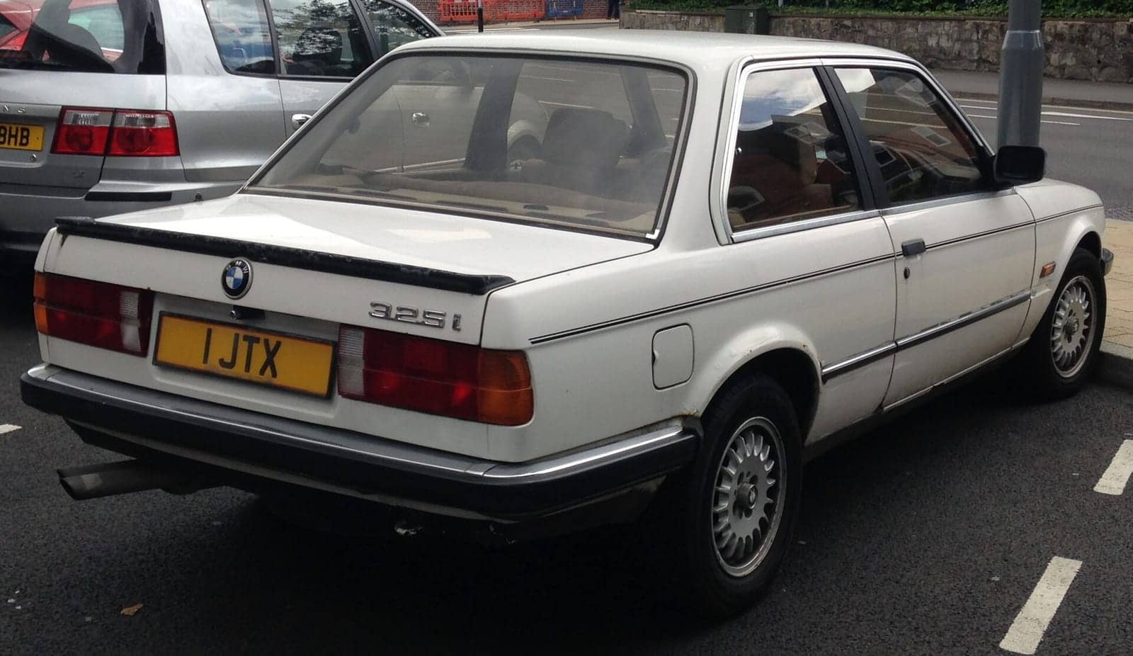 White BMW 325i two-door, rear three-quarter view