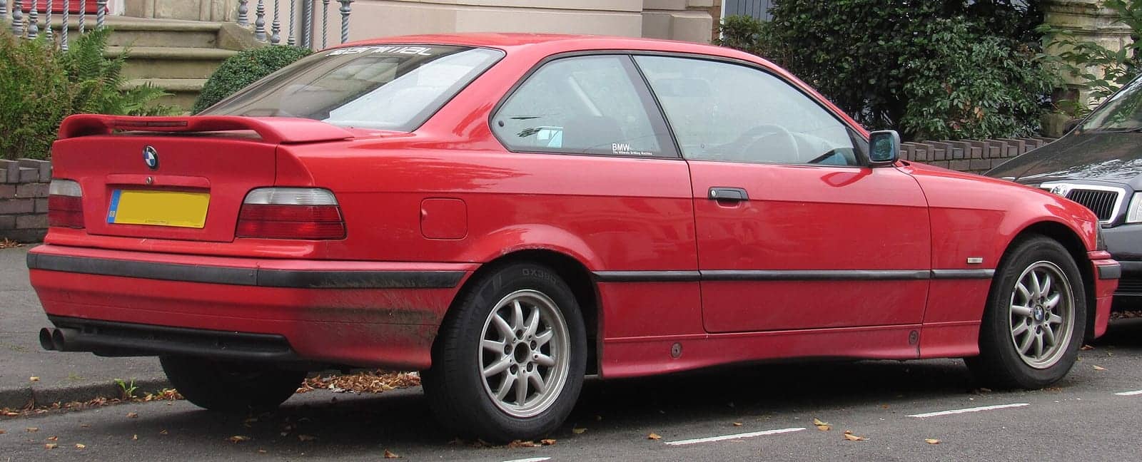 Red BMW 318is coupé, rear three-quarter view