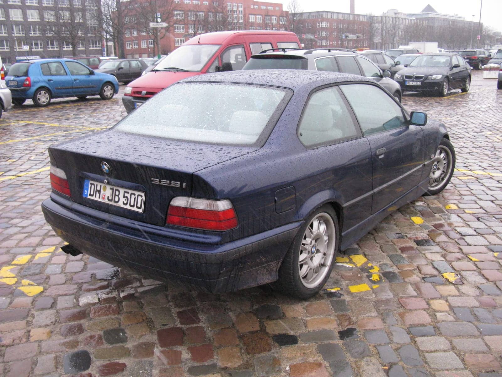 Dark blue BMW 328i coupé, rear three-quarter view