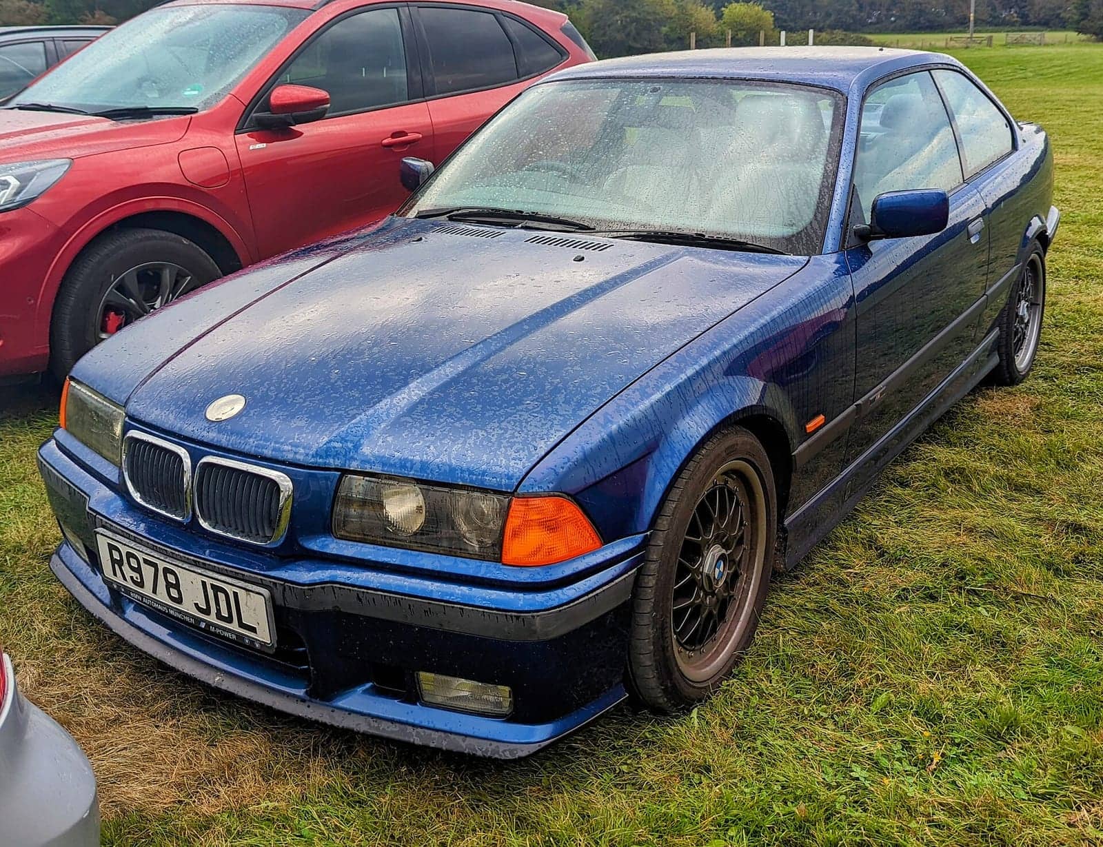 Blue BMW 328i Sport coupé, front three-quarter view