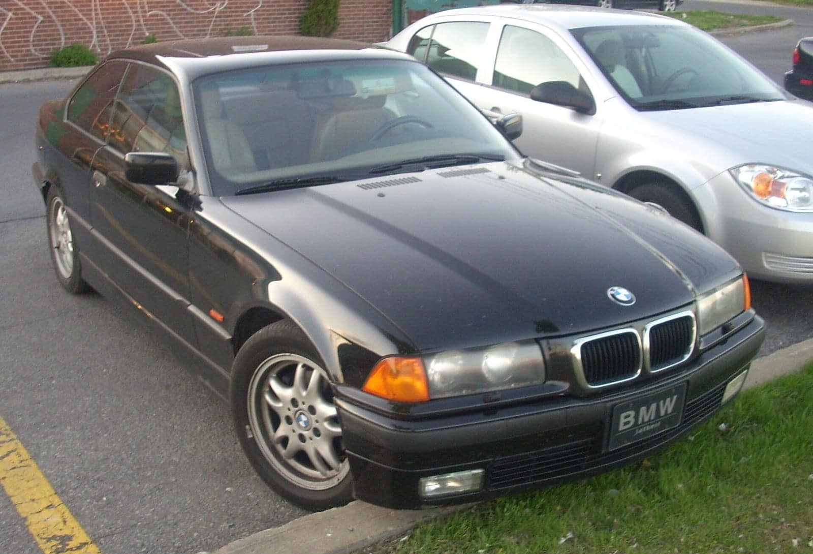 Black BMW 328is coupé, front three-quarter view