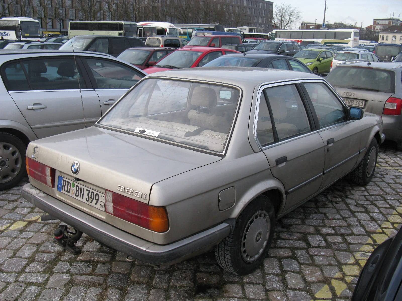 Silver BMW 323i four-door, rear three-quarter view