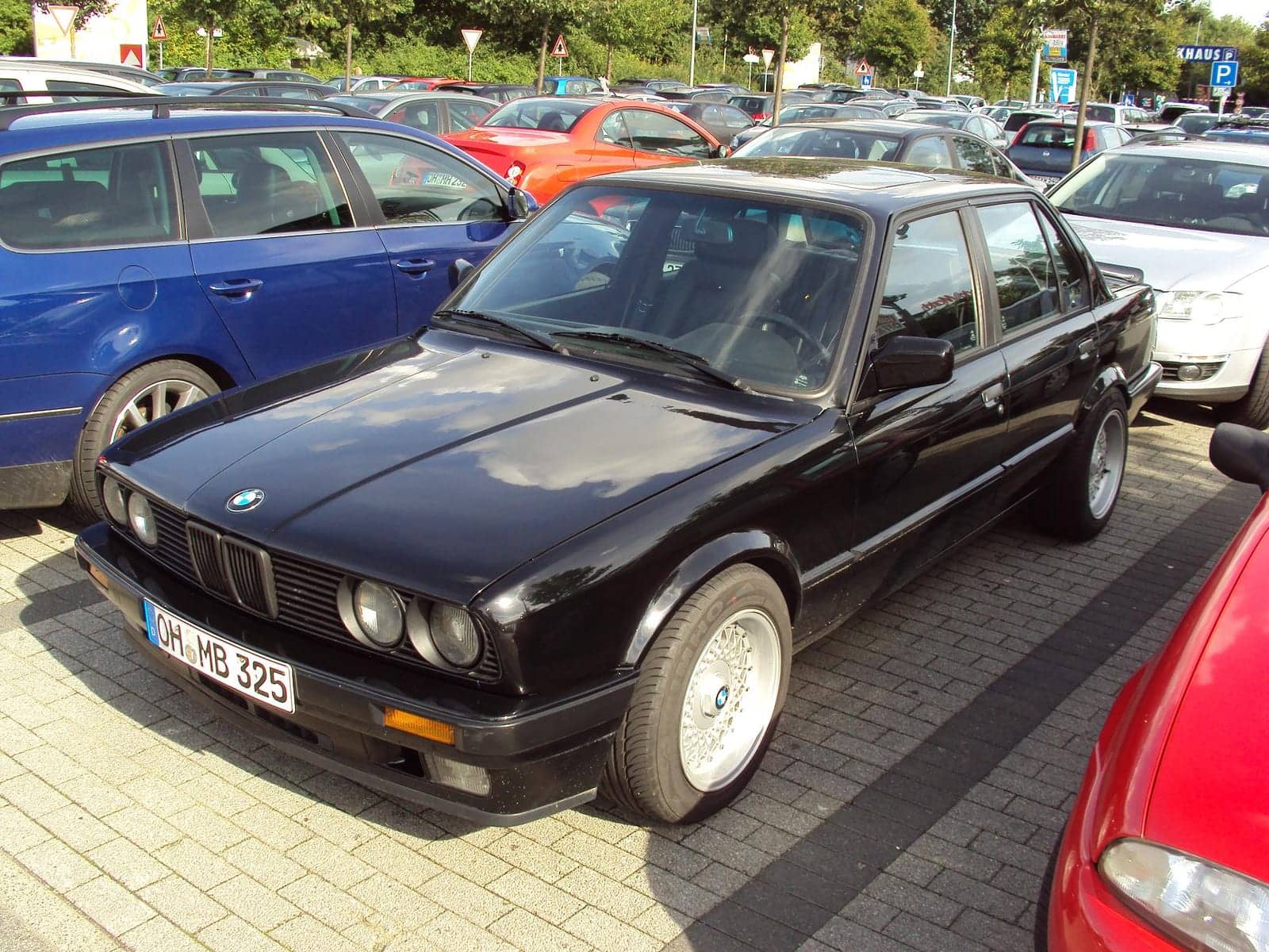 Black BMW 325i four-door, front three-quarter view
