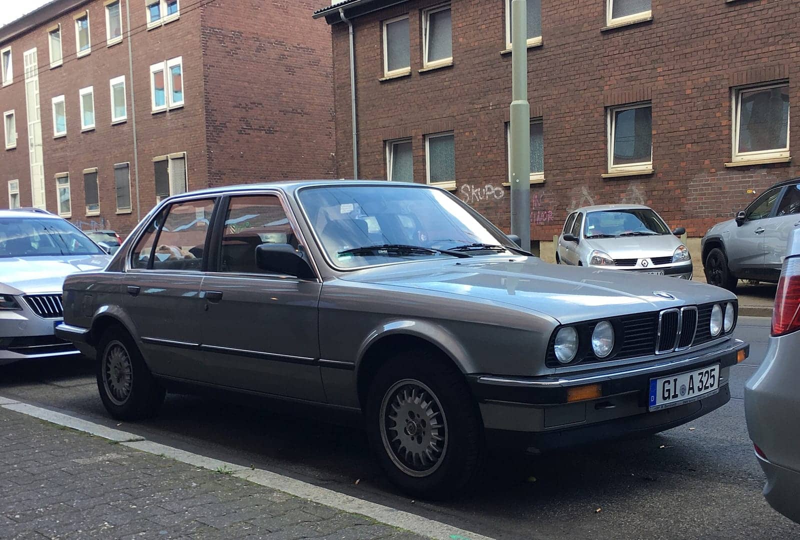 Grey BMW 325i four-door, side view