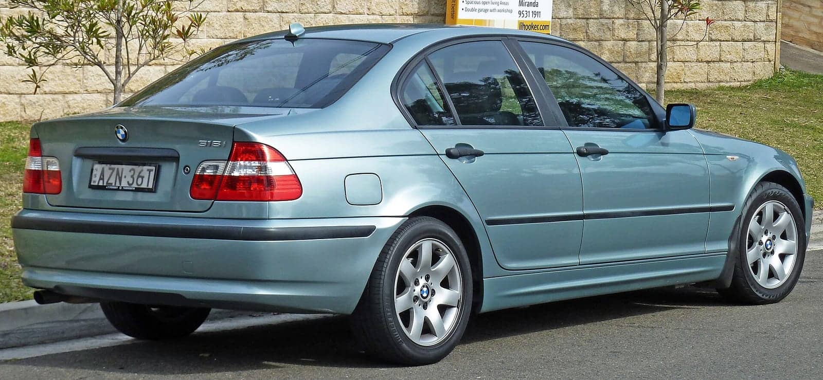 Blue BMW 318i sedan (facelift), rear three-quarter view