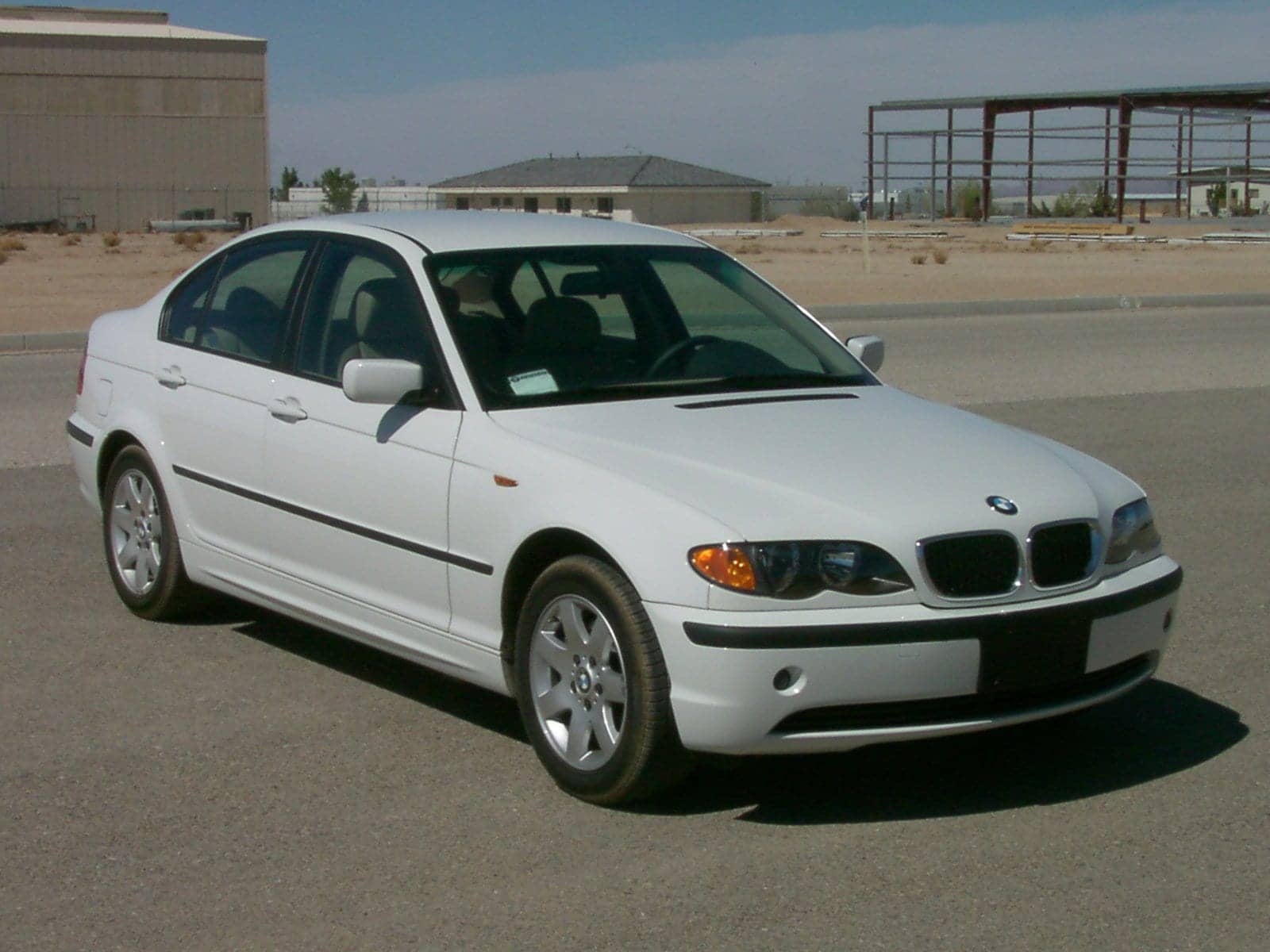 White BMW 325i sedan (facelift), front three-quarter view