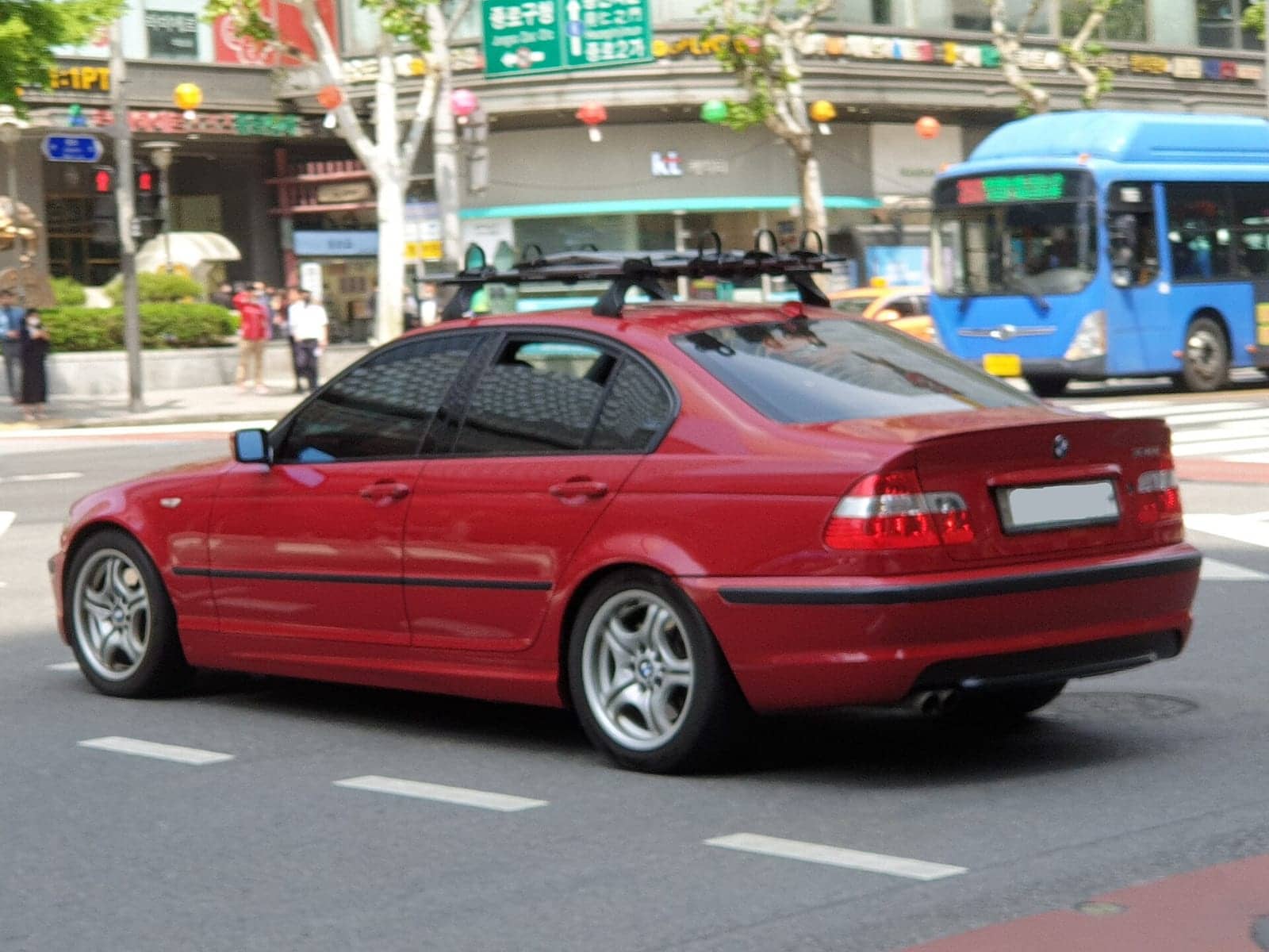Red BMW 330i M Sport sedan, side view