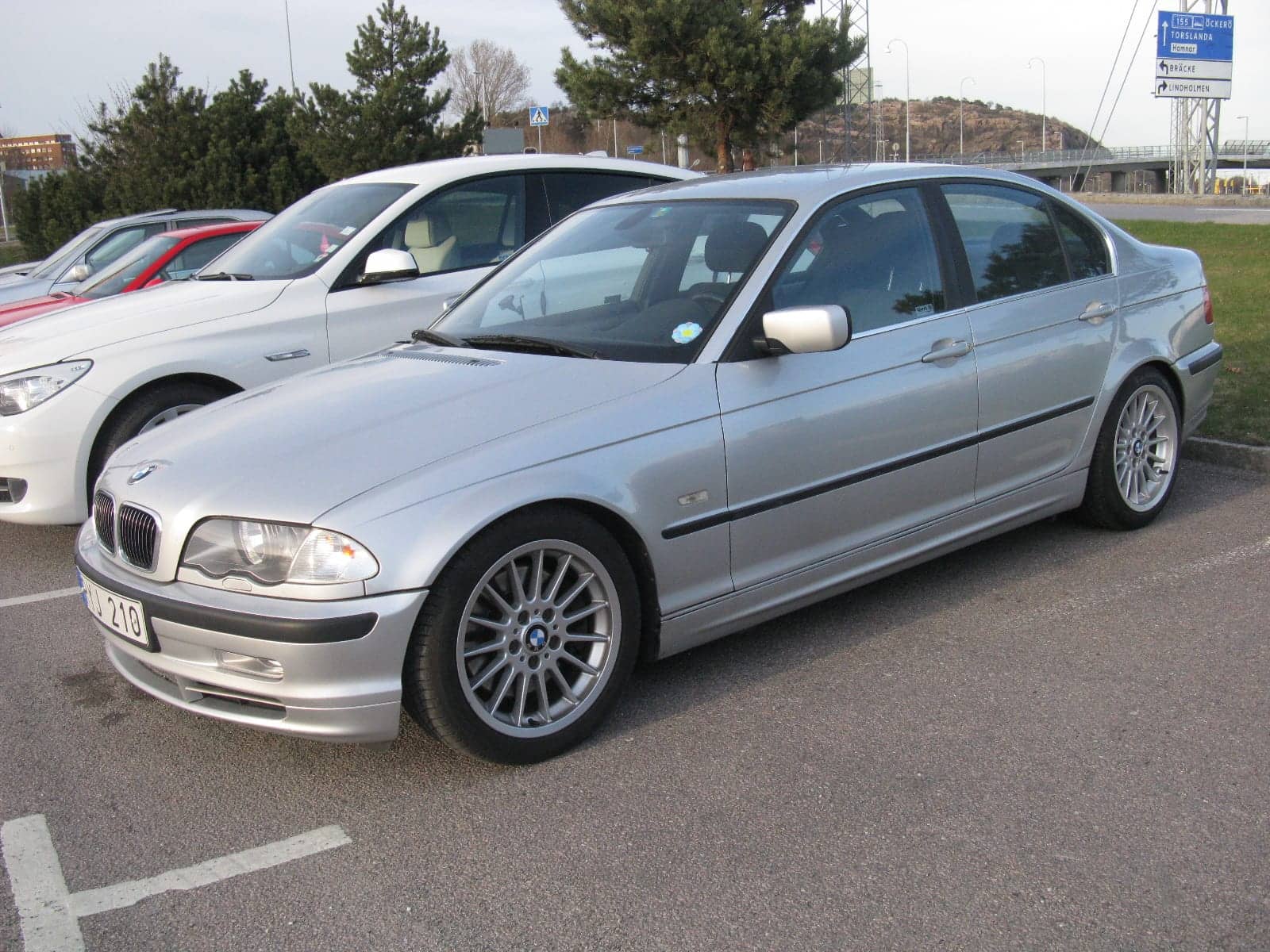 Silver BMW 330i sedan, front three-quarter view