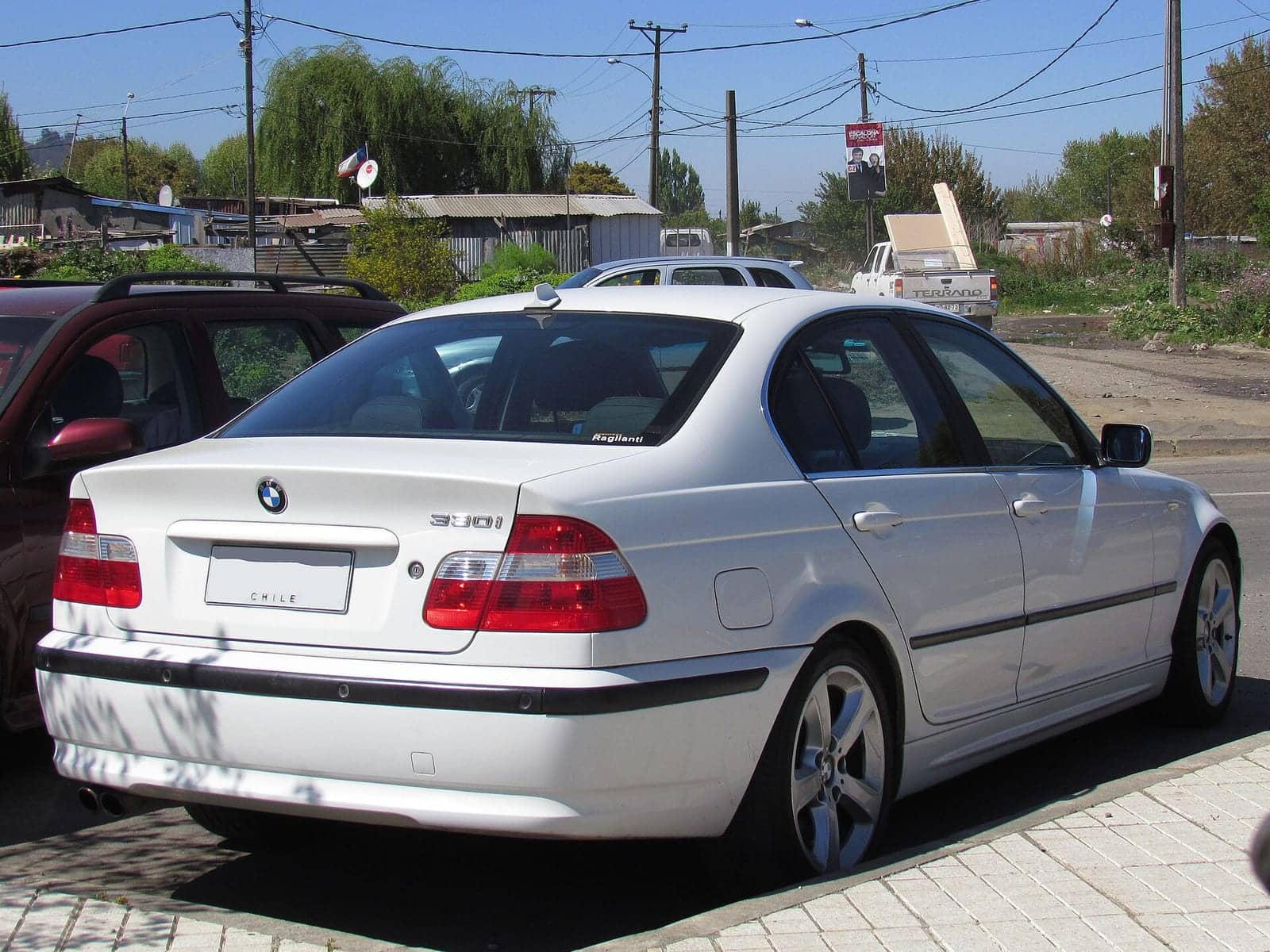 White BMW 330i sedan (facelift), rear three-quarter view