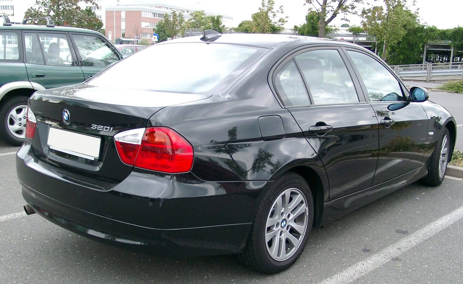 Black BMW 3 Series sedan, rear three-quarter view