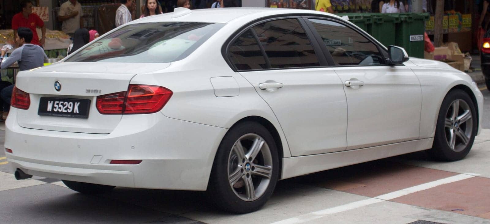 White BMW 318i sedan, rear three-quarter view