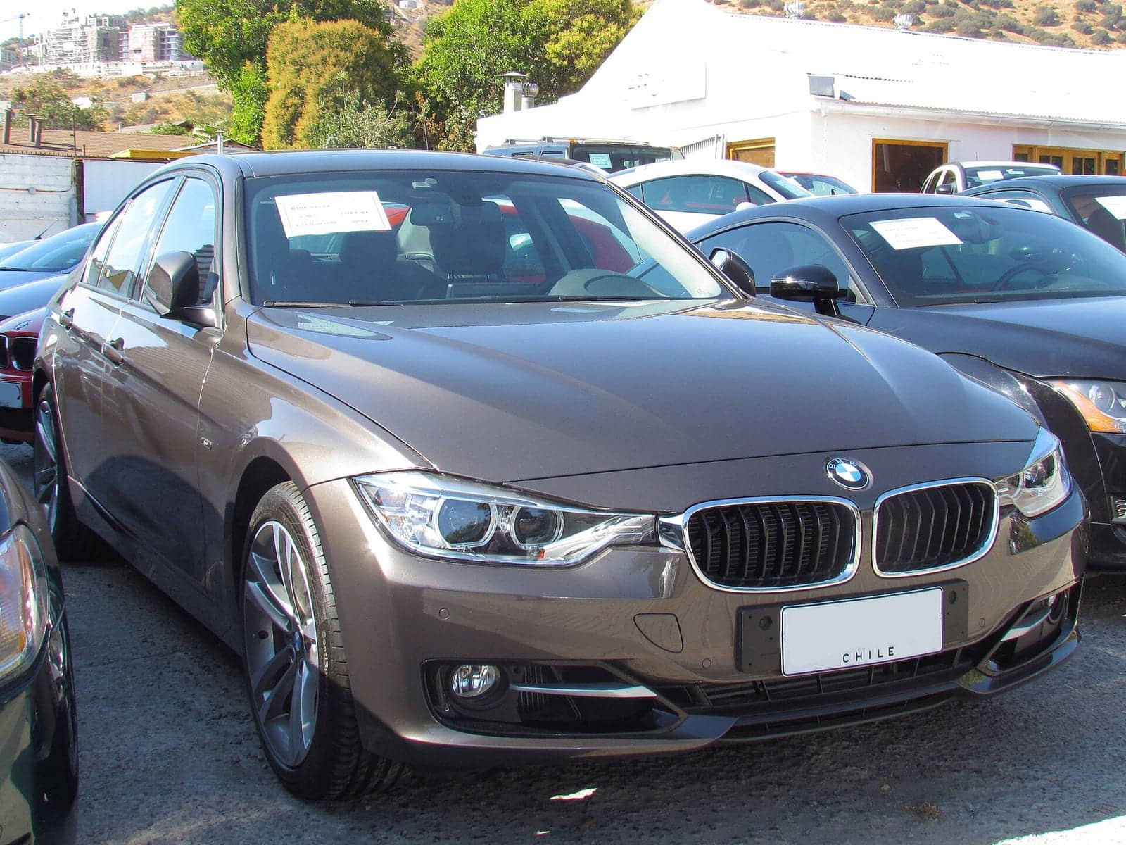 Brown BMW 325i Sport sedan, front three-quarter view