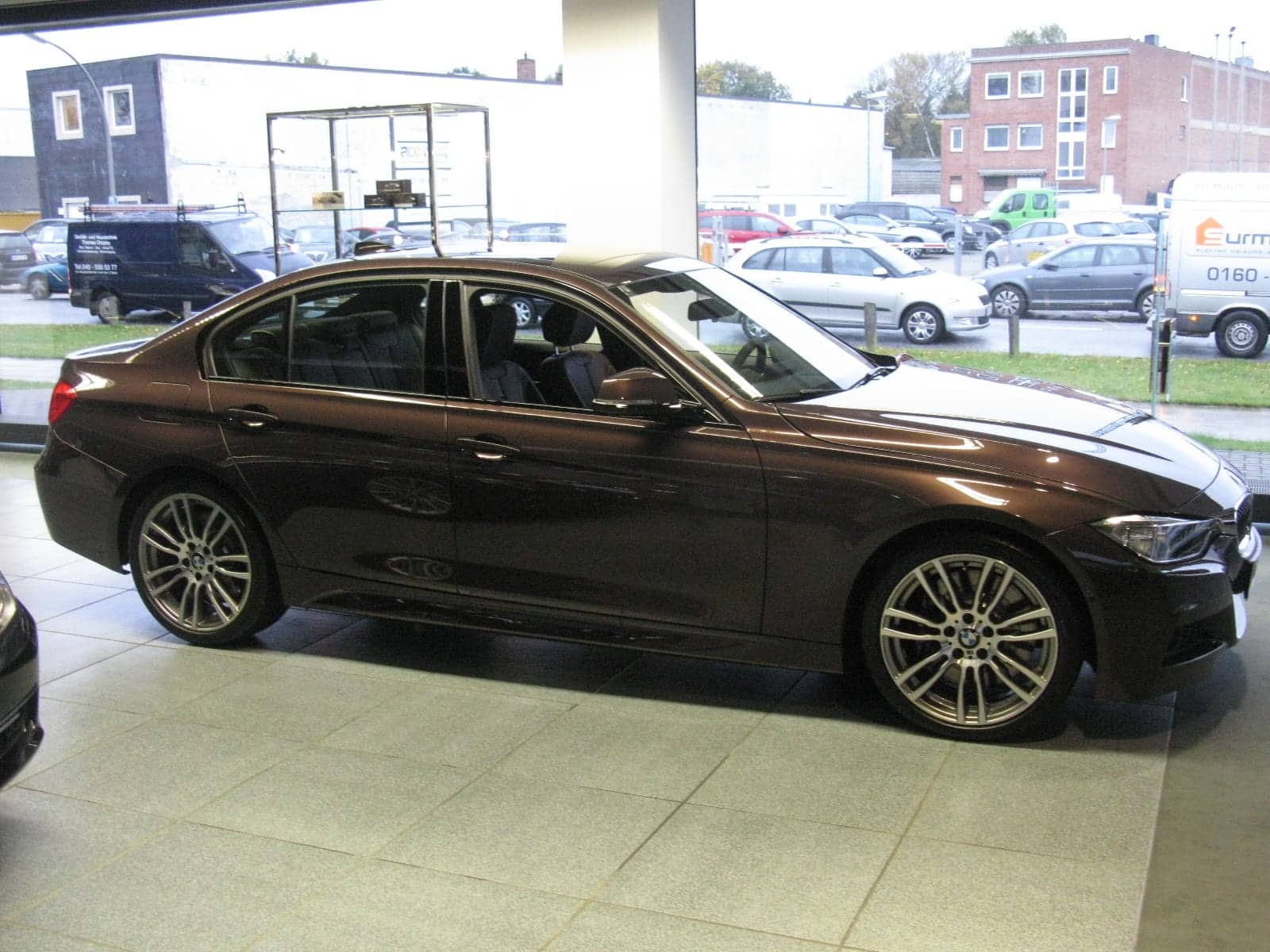 Brown BMW 335i Individual sedan, side view
