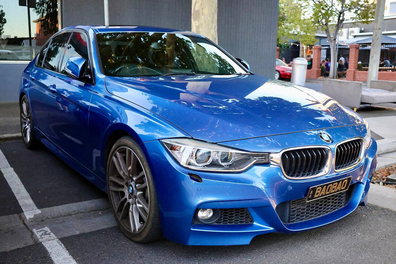 Blue BMW 335i M Sport sedan, front three-quarter view