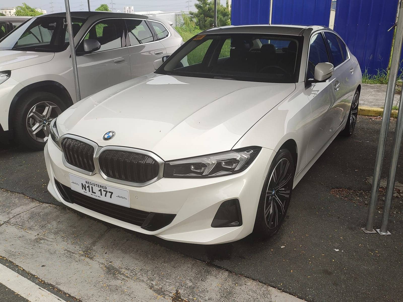 White BMW 318i sedan, front three-quarter view