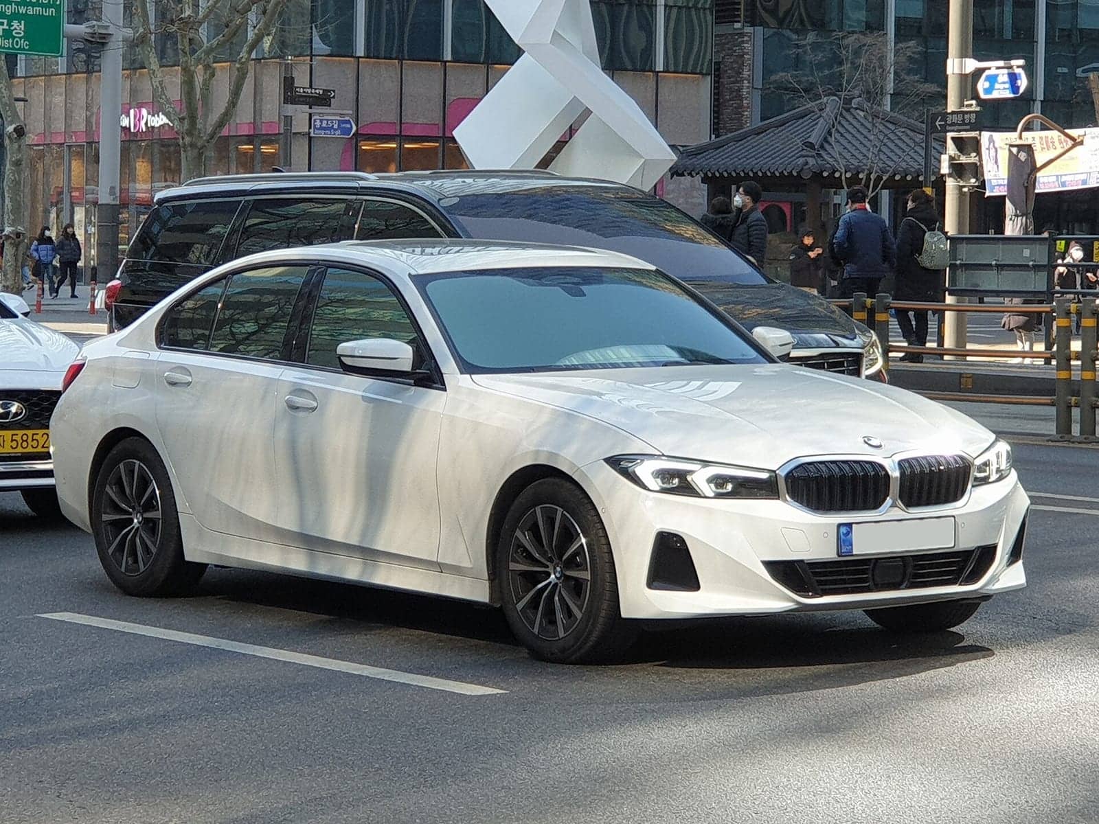 White BMW 320i sedan, front three-quarter view