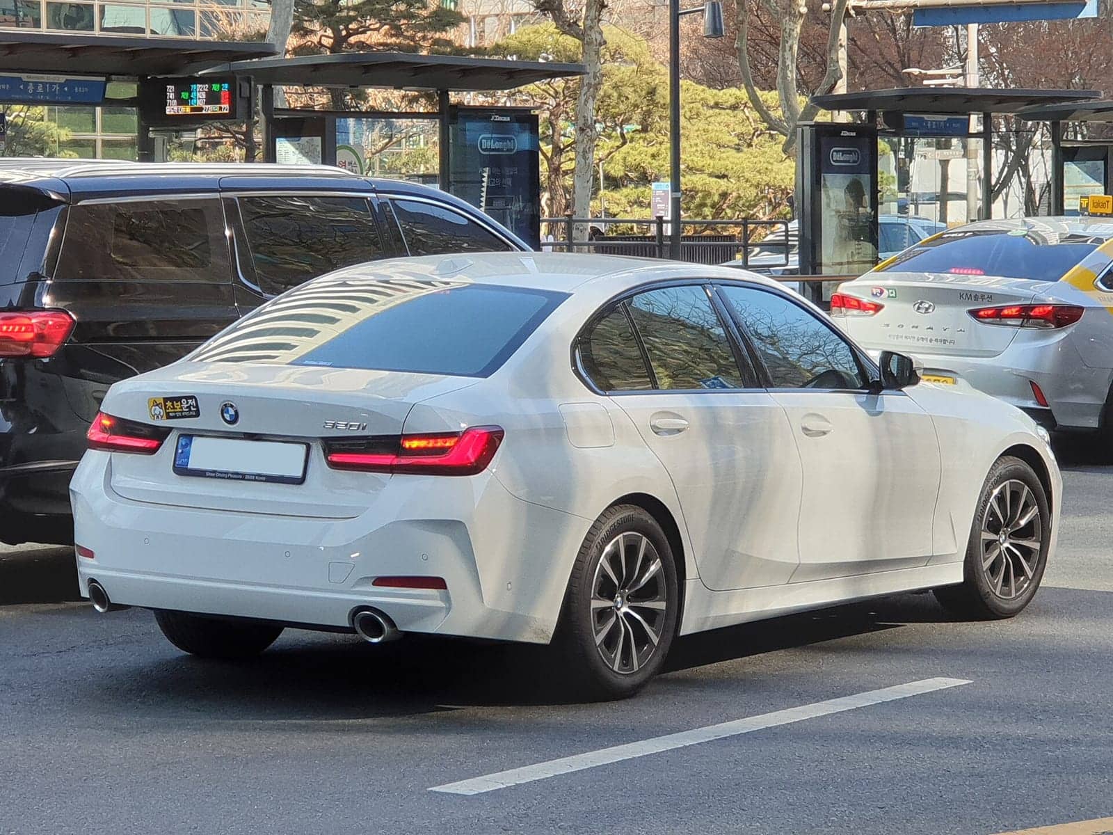 White BMW 320i sedan, rear three-quarter view