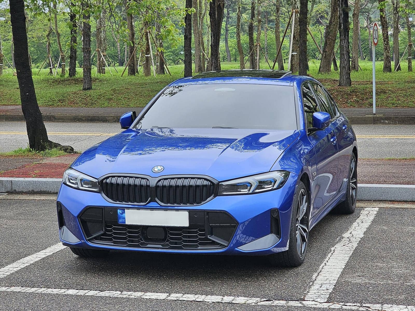 Blue BMW 330e M Sport sedan, front view