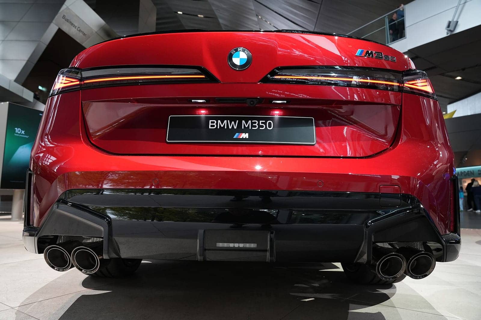 Red BMW M350 xDrive in the BMW Welt, rear view