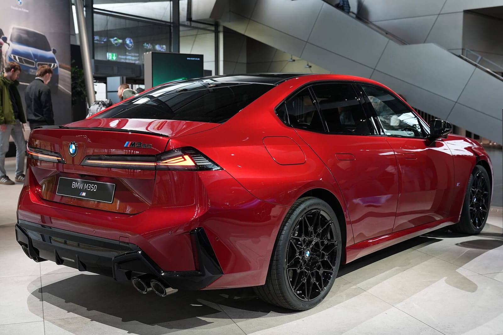 Red BMW M350 xDrive in the BMW Welt, rear three-quarter view