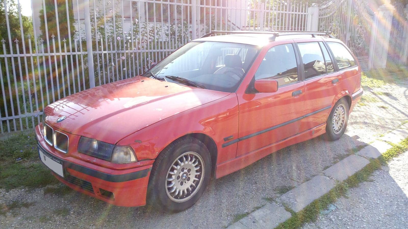 Red BMW 3 Series Touring, front three-quarter view