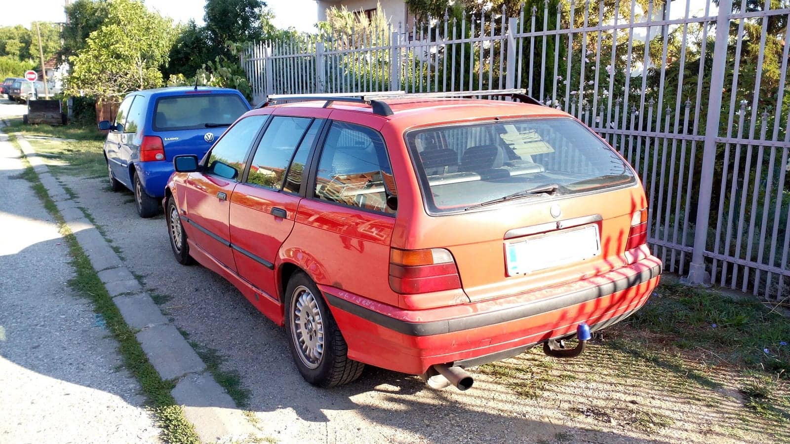 Red BMW 3 Series Touring, rear three-quarter view