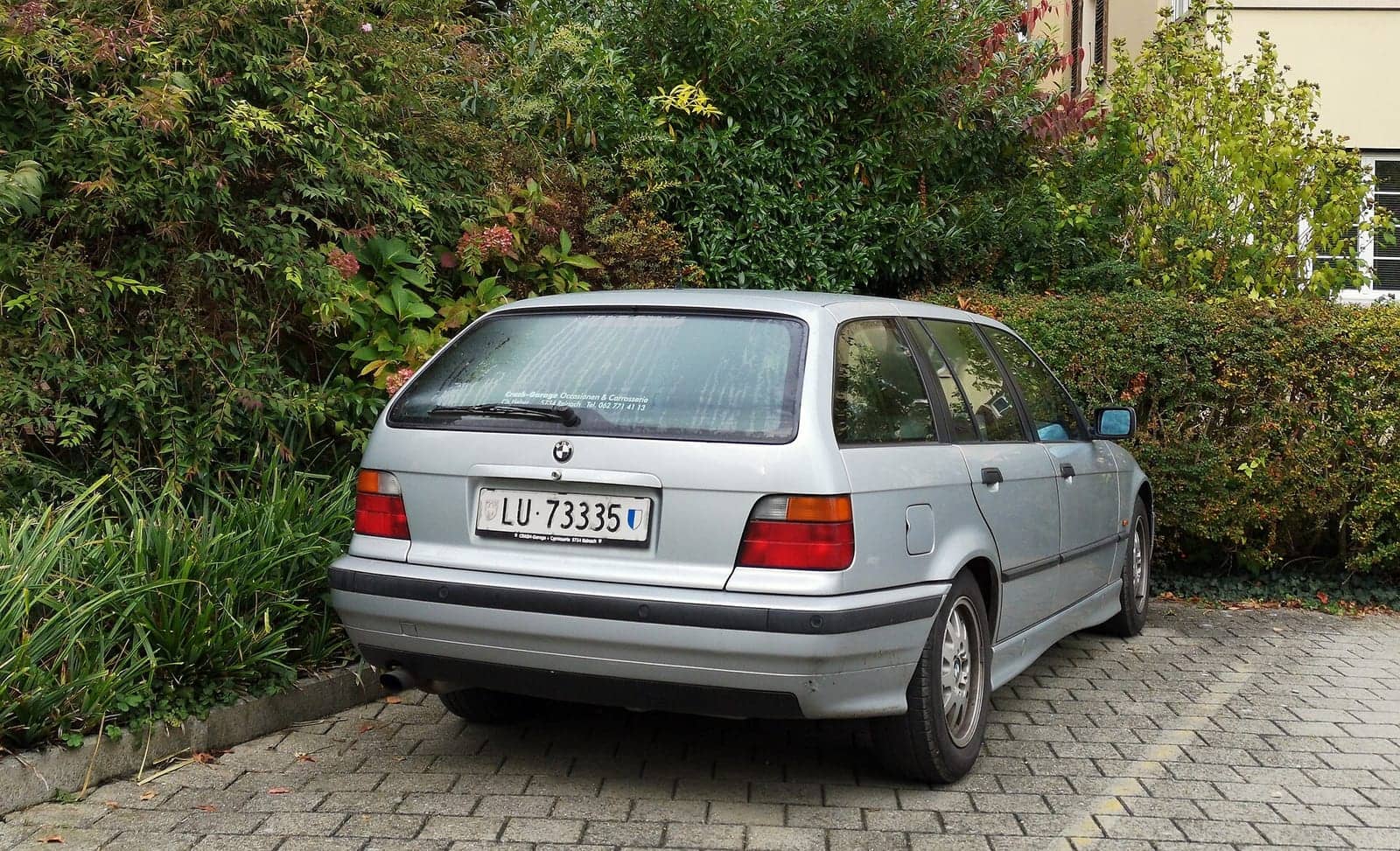 Silver BMW 3 Series Touring, rear three-quarter view