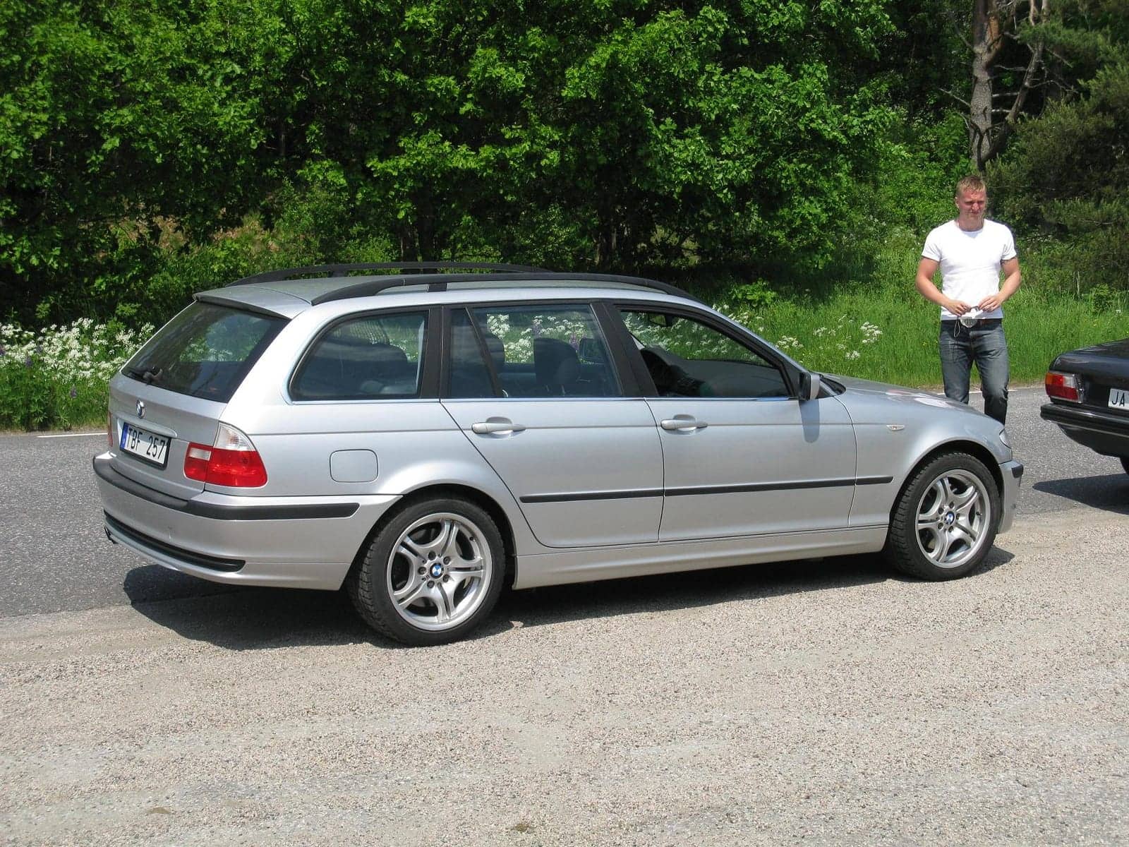 Silver BMW 330xi Touring (facelift), rear three-quarter view