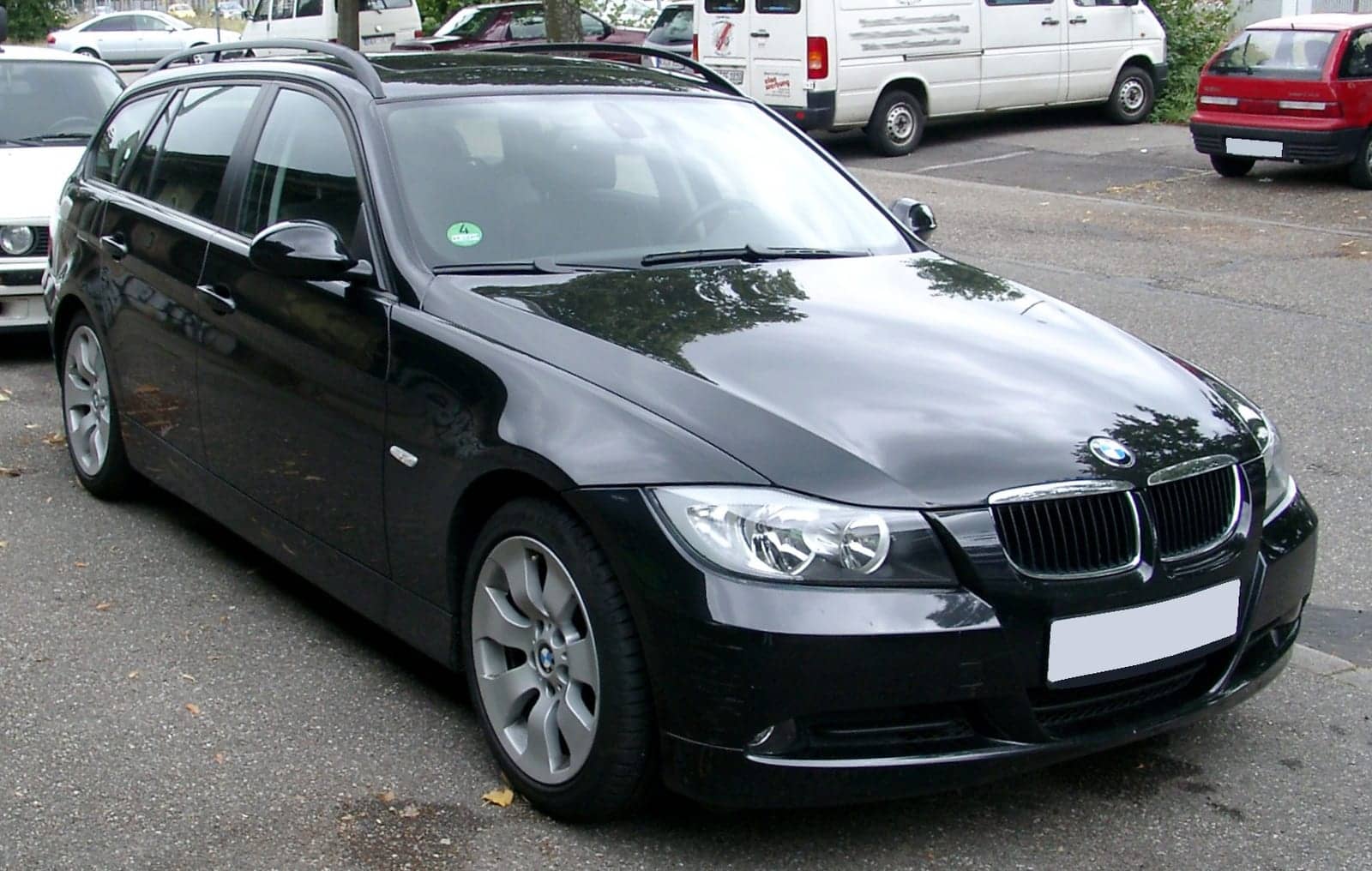 Black BMW 3 Series Touring, front three-quarter view