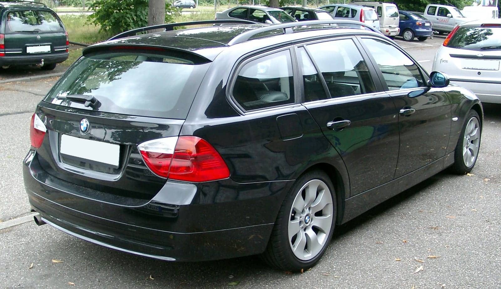 Black BMW 3 Series Touring, rear three-quarter view