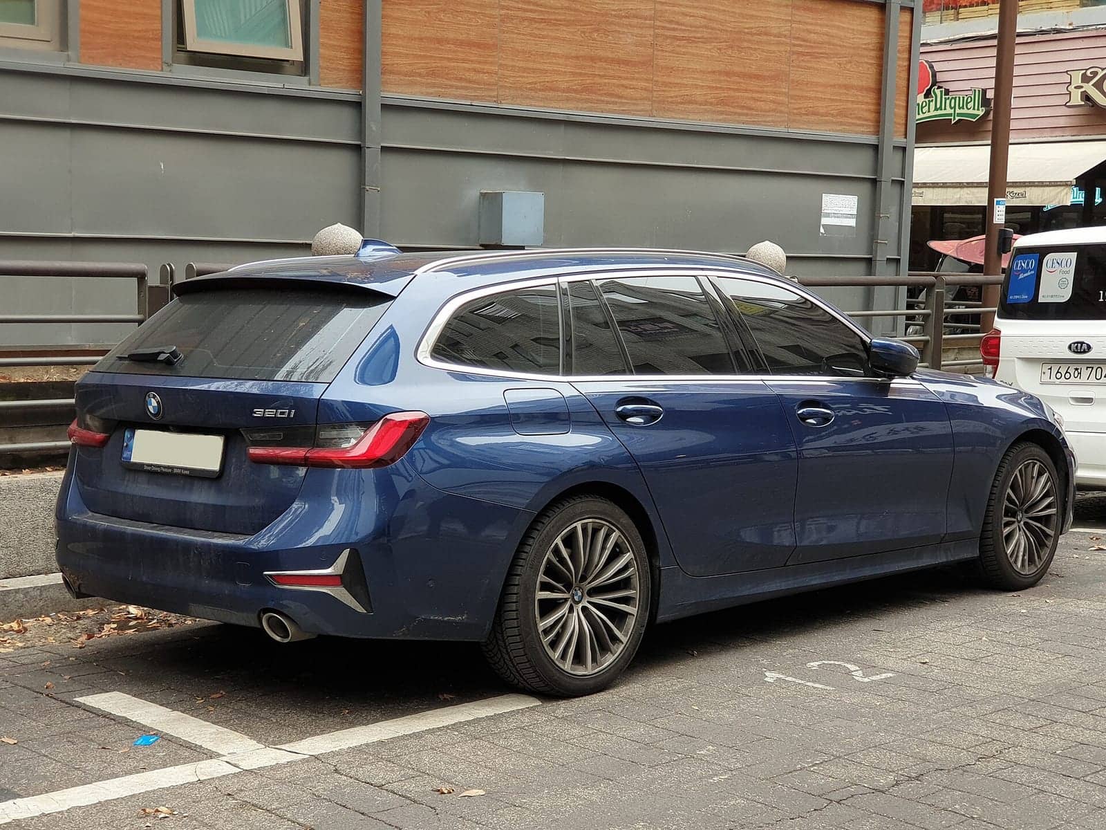 Blue BMW 320i Touring Luxury Line, rear three-quarter view