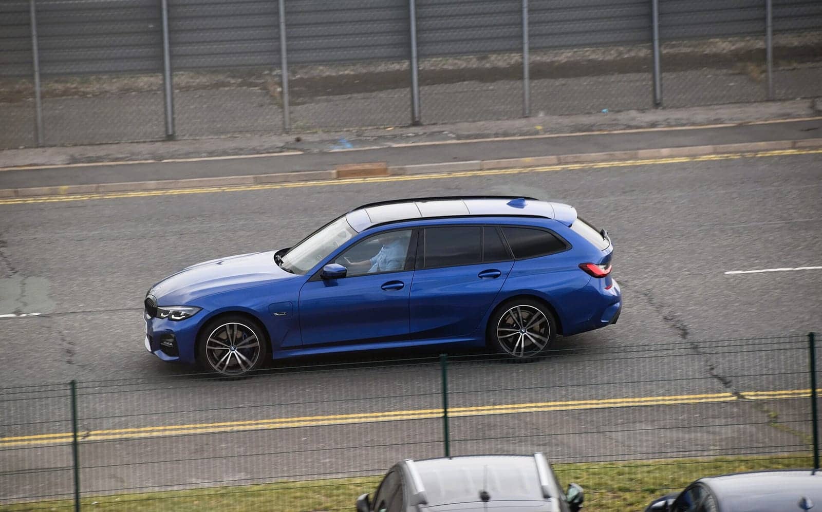 Blue BMW 330e Touring, side view