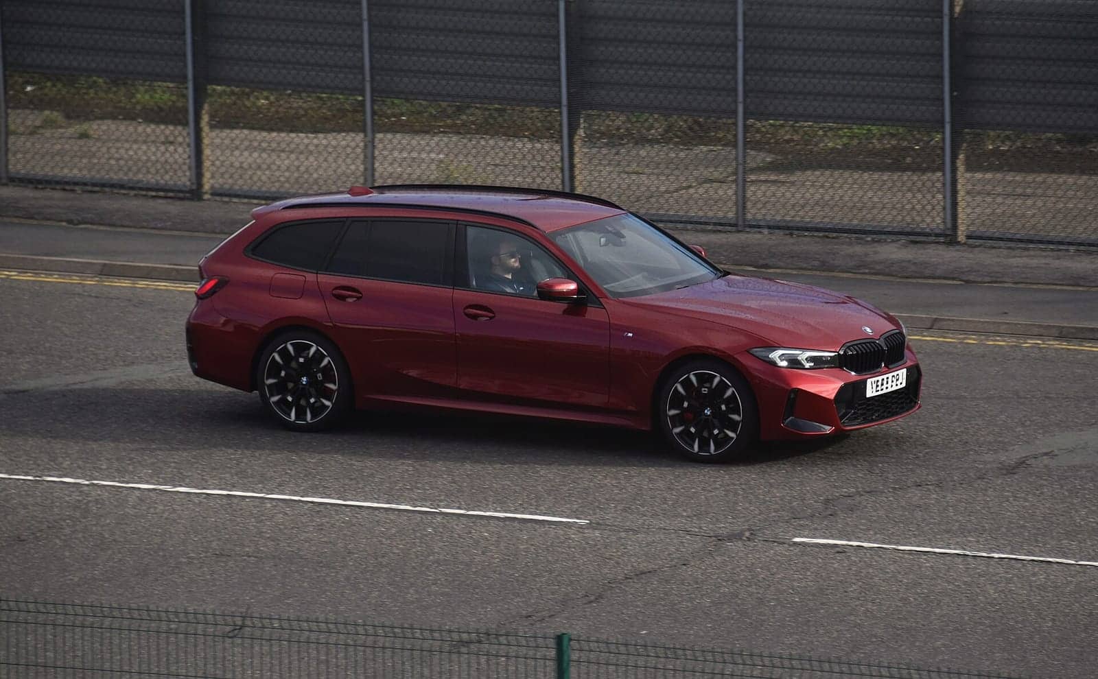 Red BMW 320d Touring, side view