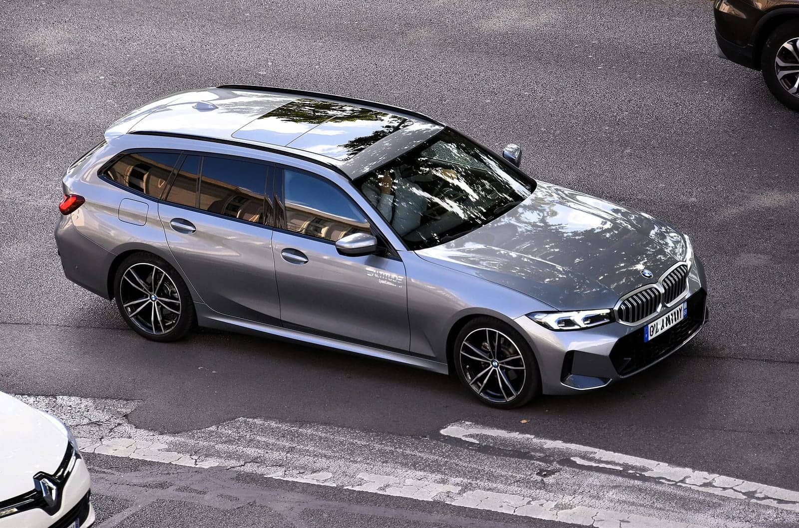 Grey BMW 320d xDrive Touring seen from above, front three-quarter view