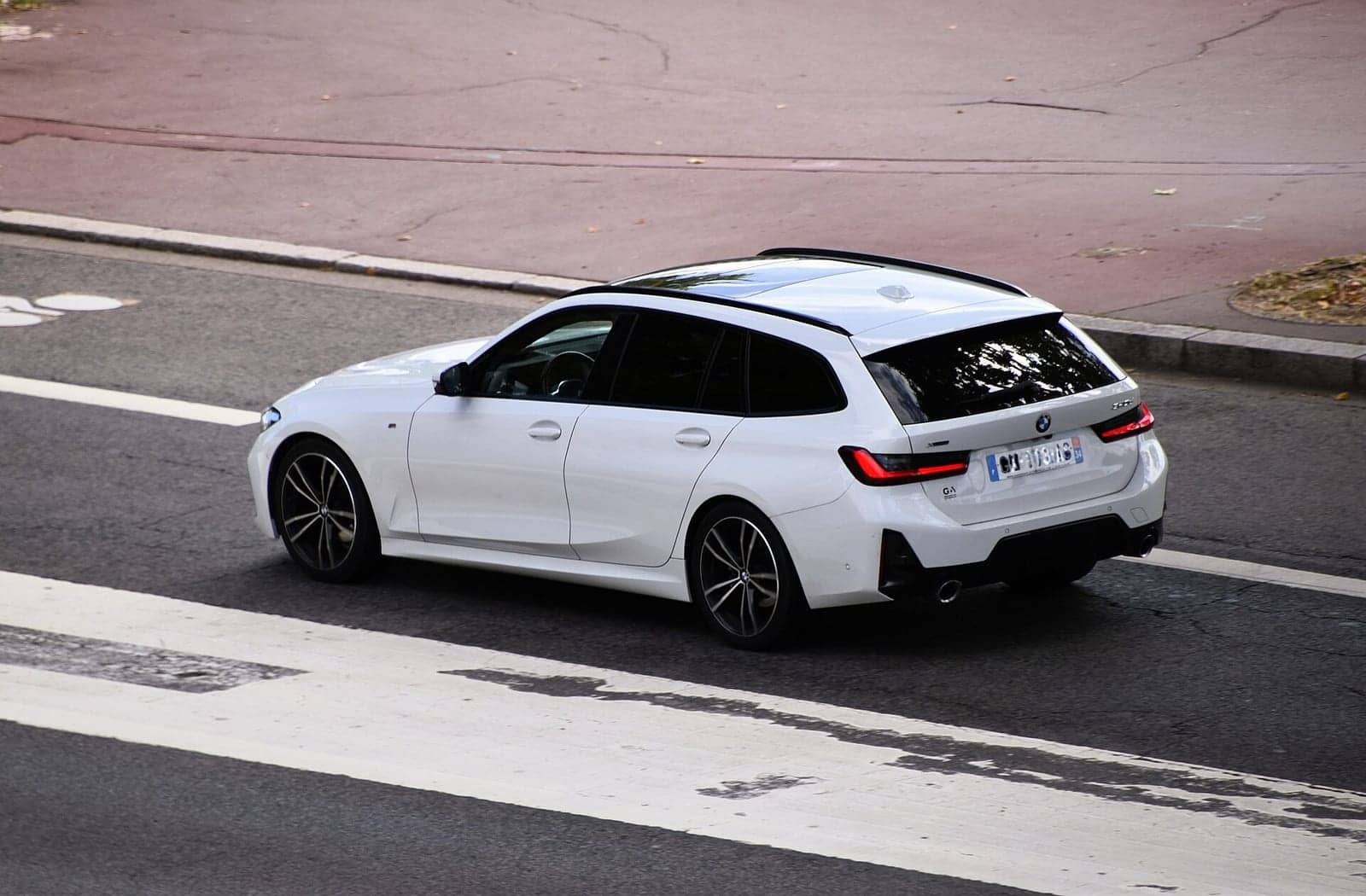White BMW 320d xDrive Touring, front three-quarter view