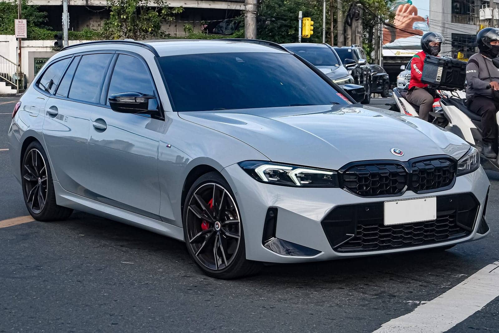 White BMW M340i Touring, front three-quarter view