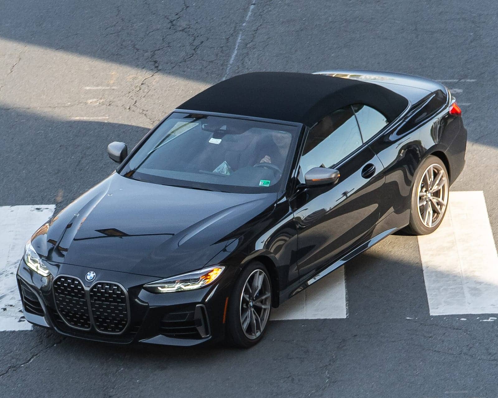 Black BMW M440i convertible seen from above, front three-quarter view