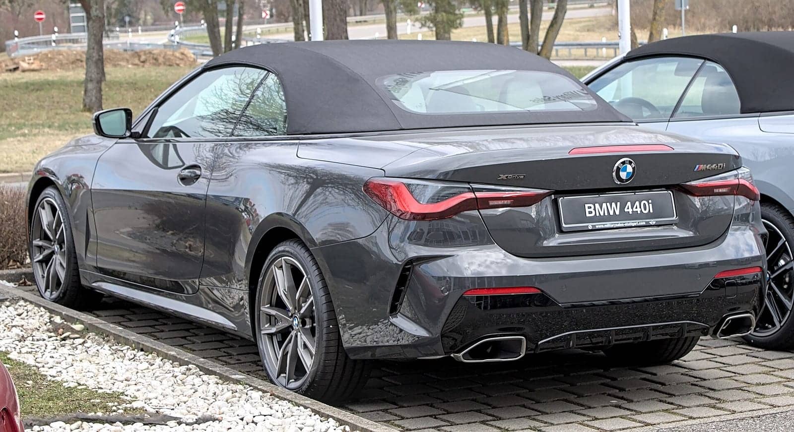 Grey BMW M440i convertible, rear three-quarter view