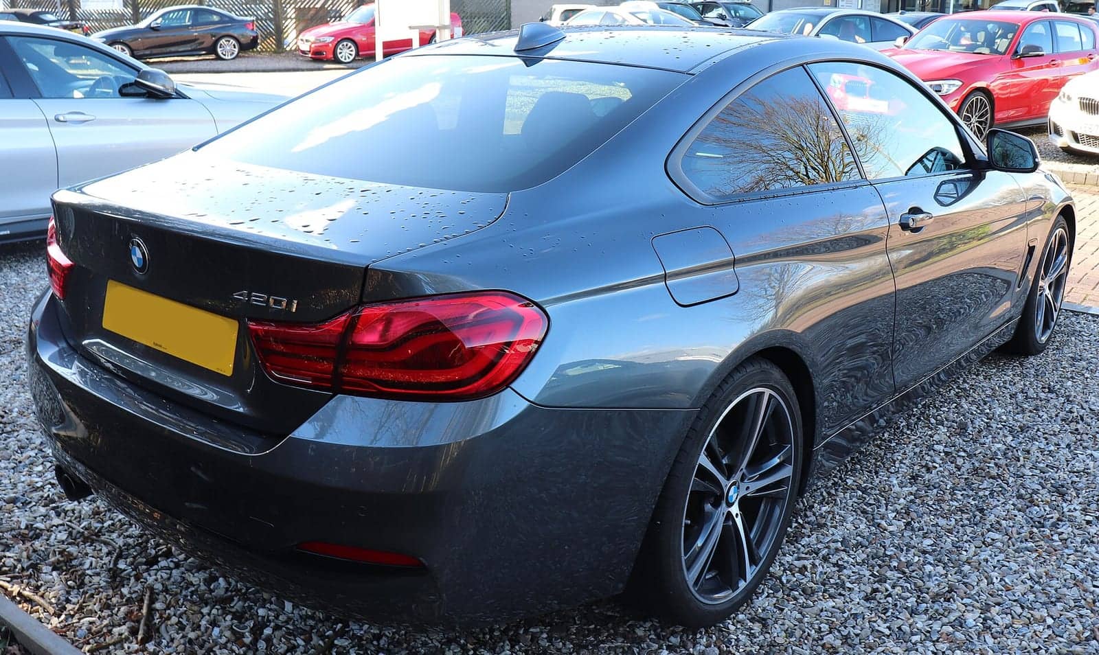 Grey BMW 420i Sport coupé (facelift), rear three-quarter view