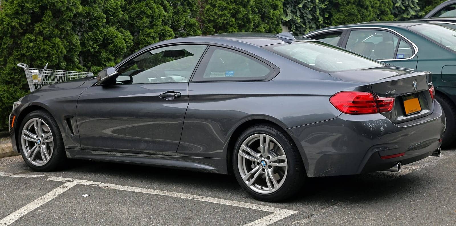 Grey BMW 435i xDrive coupé, rear three-quarter view