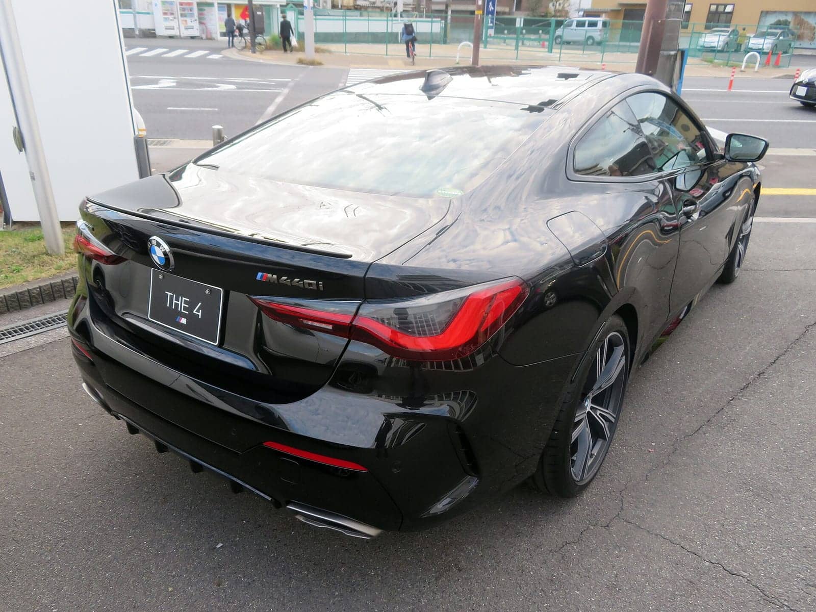 Black BMW M440i xDrive coupé, rear three-quarter view