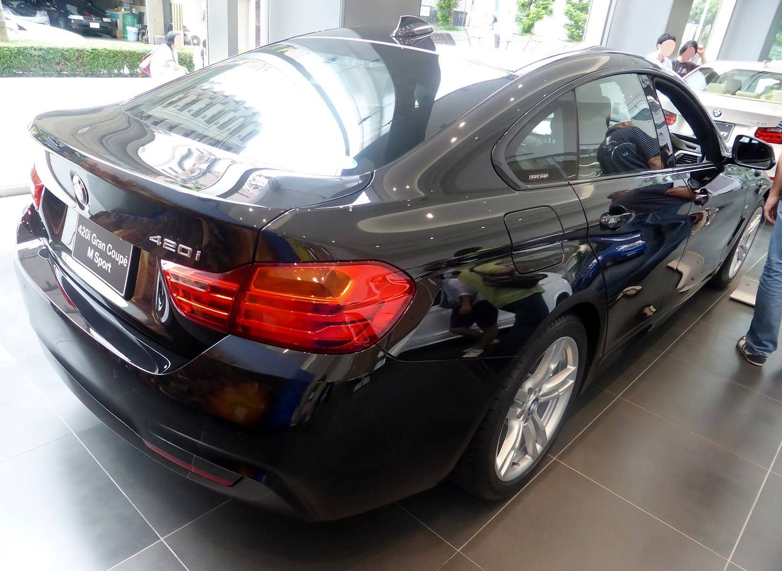 Black BMW 420i Gran Coupé M Sport, rear three-quarter view