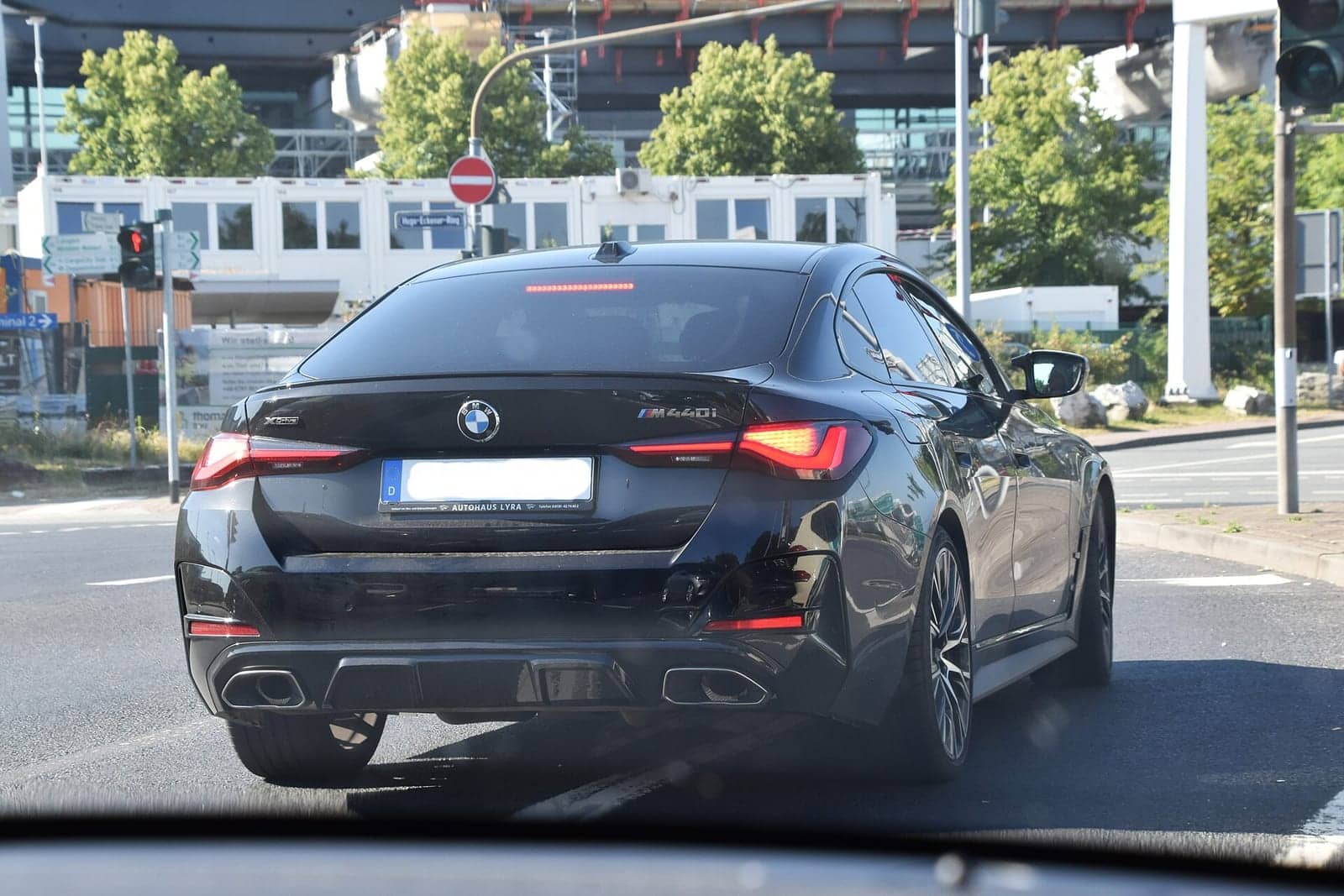 Black BMW M440i xDrive Gran Coupé, rear three-quarter view